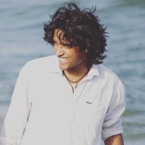 A photo of Mukesh Ravichandran, a student of immersion program squad #1, 2017 batch, smiling at the camera in casual attire.